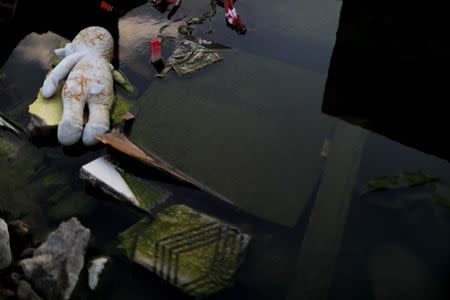 A toy lies among debris of a destroyed house in Balaroa neighbourhood hit by an earthquake and ground liquefaction in Palu, Central Sulawesi, Indonesia, October 10, 2018. REUTERS/Jorge Silva