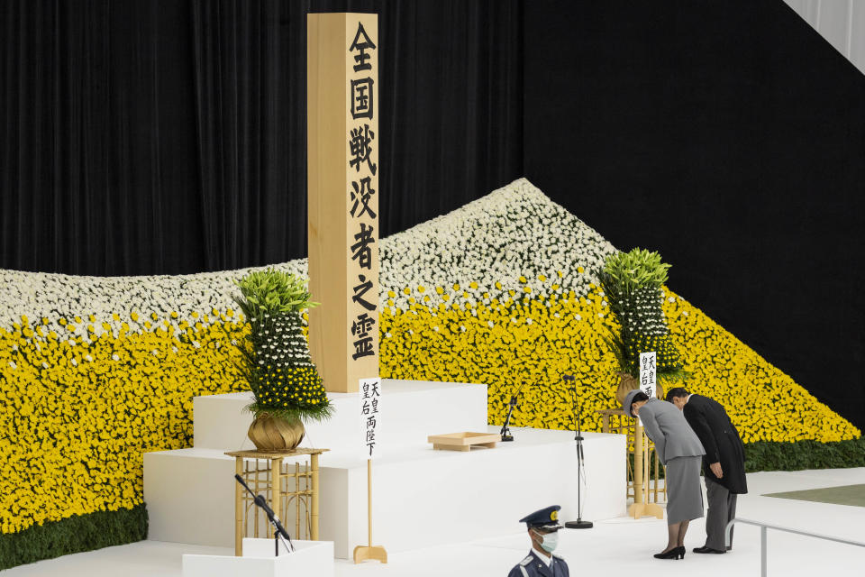 Japan's Emperor Naruhito and Empress Masako bow as they attend a memorial service marking the 77th anniversary of Japan's World War II defeat, at the Nippon Budokan hall in Tokyo, Monday, Aug. 15, 2022. (Yuichi Yamazaki/Pool Photo via AP)