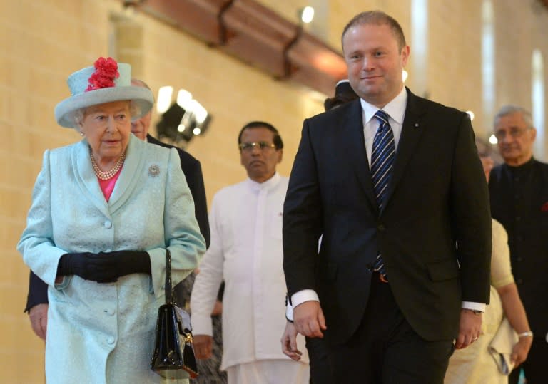 Queen Elizabeth II and Malta's Prime Minister Joseph Muscat arrive to attend the opening ceremony of the Commonwealth Heads of Government Meeting in Valletta on November 27, 2015