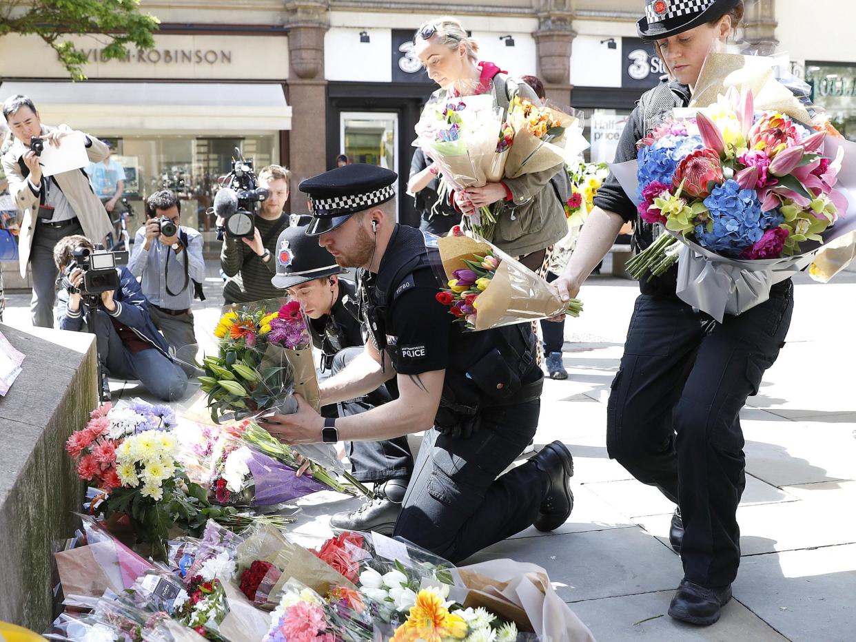 Flowers are left in St Ann's Square, Manchester, the day after a suicide bomber killed 22 people, including children: Press Association