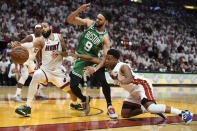 Miami Heat forward Caleb Martin, left, scrambles for the ball after guard Kyle Lowry, right, stripped it from Boston Celtics guard Derrick White (9) as he went to the basket during the second half of Game 6 of the NBA basketball Eastern Conference finals, Saturday, May 27, 2023, in Miami. (AP Photo/Michael Laughlin)