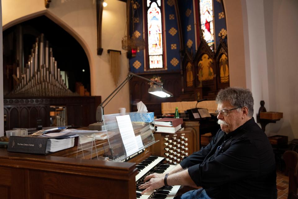 Mark Wright, music director at Christ Episcopal Church, plays a pipe organ on Tuesday, May 9, 2023. Wright is working to repair the organ was damaged during a 1978 Christmas Eve arson and from years of neglect. 