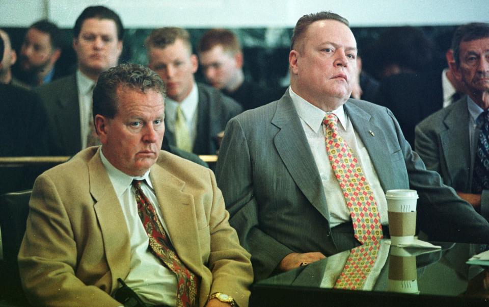 FILE - "Hustler" magazine publisher Larry Flynt, right, and his brother Jimmy listen to the judge pass sentence after agreeing to a plea bargain with prosecutors in Hamilton County Court on May 12, 1999, in Cincinnati. Flynt, who turned "Hustler" magazine into an adult entertainment empire while championing First Amendment rights, has died at age 78. His nephew, Jimmy Flynt Jr., told The Associated Press that Flynt died Wednesday, Feb. 10, 2021, of heart failure at his Hollywood Hills home in Los Angeles. (AP Photo/Tom Uhlman, File)