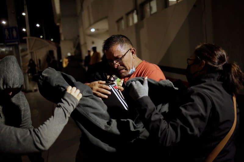 Ortega is embraced by his family after being deported from U.S. to Mexico in Ciudad Juarez