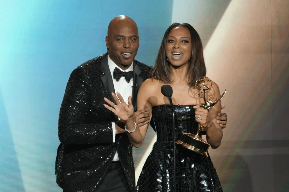 Kevin Frazier, left, and Nischelle Turner accept the award for outstanding entertainment news series for "Entertainment Tonight" during the 50th Daytime Emmy Awards on Friday, Dec. 15, 2023, at the Westin Bonaventure Hotel in Los Angeles. (AP Photo/Chris Pizzello)