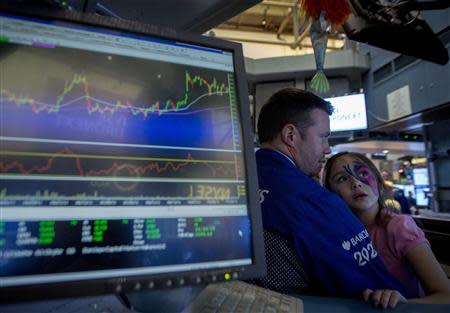 Trader Frank Masiello talks with his niece at his post on the floor of the New York Stock Exchange November 29, 2013. REUTERS/Brendan McDermid