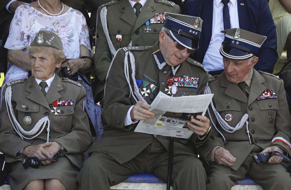 Polish war veterans look at a paper before a memorial ceremony marking the 80th anniversary of the start of World War II in Warsaw, Poland, Sunday, Sept. 1, 2019. (AP Photo/Petr David Josek)