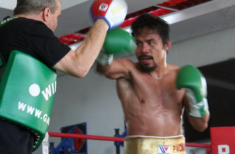 Philippine boxing hero Manny Pacquiao (R) is seen training with his coach Freddie Roach at a gym in General Santos City, in the Philippines, on October 24, 2013
