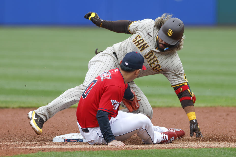 Cleveland Guardians' Andrés Giménez tags out San Diego Padres' Jorge Alfaro at second base during the first inning in the second baseball game of a doubleheader, Wednesday, May 4, 2022, in Cleveland. (AP Photo/Ron Schwane)