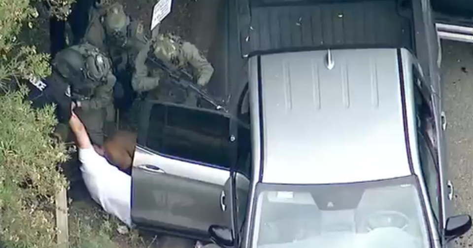 SWAT teams pull what appears to be a suspect from his vehicle after a deadly shooting earlier that day (ABC7)