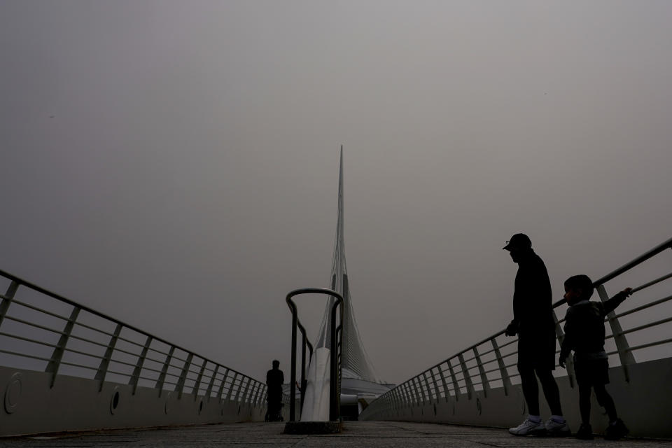 FILE - A haze is seen over the Milwaukee Art Museum, Tuesday, June 27, 2023, in Milwaukee. Forecasters say there won’t be large breaks for much of America anytime soon from eye-watering dangerous smoke from fire-struck Canada. (AP Photo/Morry Gash, File)