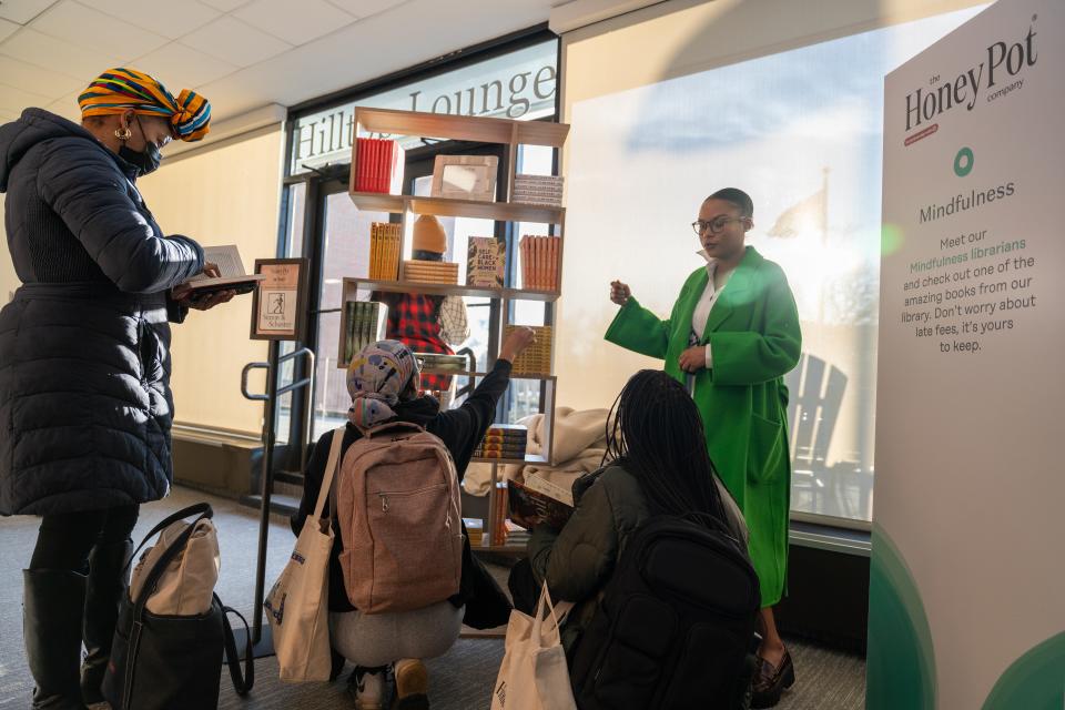 Students immerse themselves in the activation as Nadia Sims, Program Lead for Black Folx Wellness Collective Book Club, leads the mini library and resource center sponsored by Simon & Schuster Imprints.
