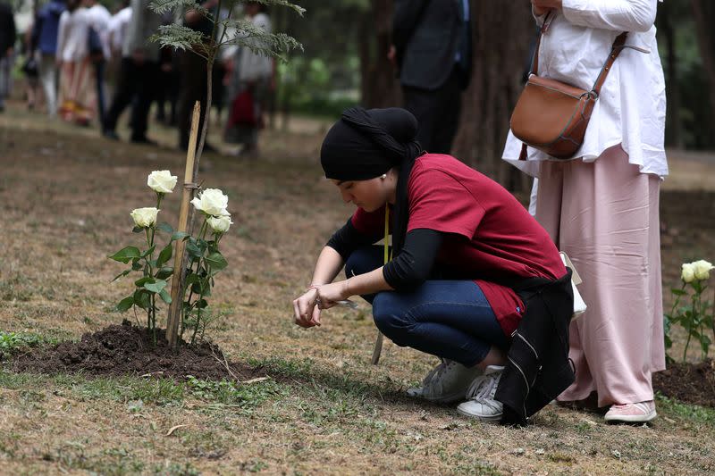 A family member reacts after laying a flower during a memorial ceremony for the victims of the Ethiopian Airlines Flight ET302 Boeing 737 Max plane crash, at the French Embassy in Addis Ababa