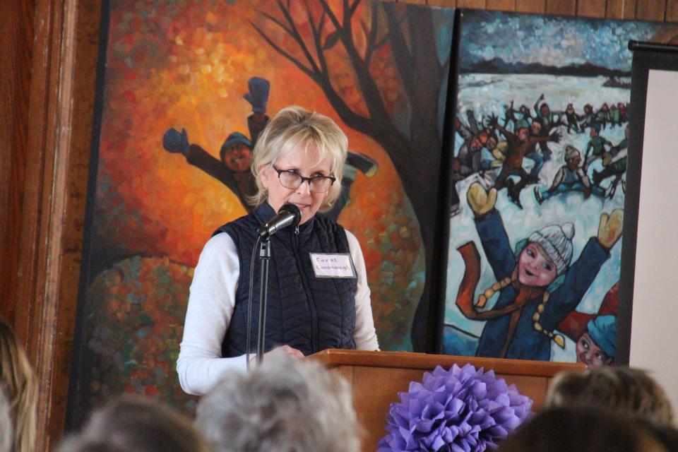 Carol Cavanaugh welcomes attendees to the 2020 International Women's Day Coffee.
