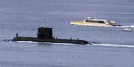 A Rivercat ferry passes by the Royal Australian Navy's newest Collins class submarine, HMAS Waller, as it leaves Sydney Harbour in this May 4, 2000 file photo. REUTERS/David Gray/Files