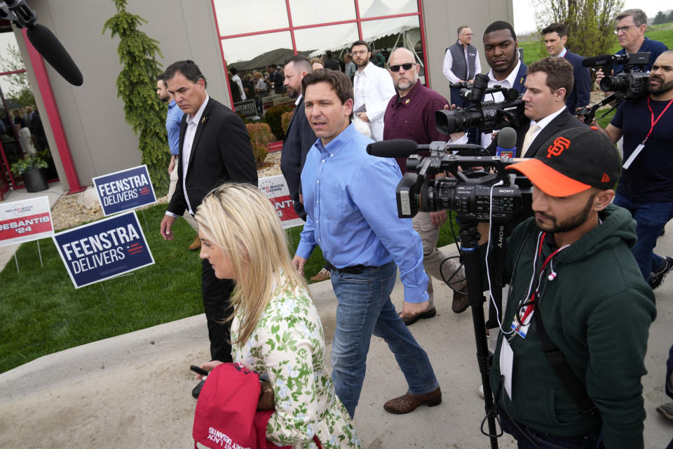 FILE - Florida Gov. Ron DeSantis, center, leaves a fundraising picnic for Rep. Randy Feenstra, R-Iowa, May 13, 2023, in Sioux Center, Iowa. In the coming weeks, at least four additional candidates are expected to launch their own presidential campaigns, joining a field that already includes DeSantis, Sen. Tim Scott, R-S.C., former U.N. Ambassador Nikki Haley, former Arkansas Gov. Asa Hutchinson, tech billionaire Vivek Ramaswamy and several longer-shots like conservative talk radio host Larry Elder. (AP Photo/Charlie Neibergall, File)