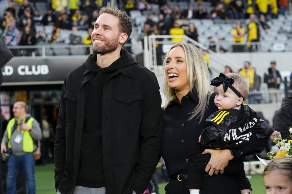 Mar 16, 2024; Columbus, Ohio, USA; Former Columbus Crew player Josh Williams stands with his girlfriend Alivia Huffine and daughter, Arlo, as he is honored prior to the MLS soccer match between the Columbus Crew and New York Red Bulls at Lower.com Field. Mandatory Credit: Adam Cairns-USA TODAY Sports