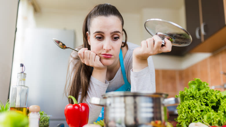 Stressed woman cooking in kitchen