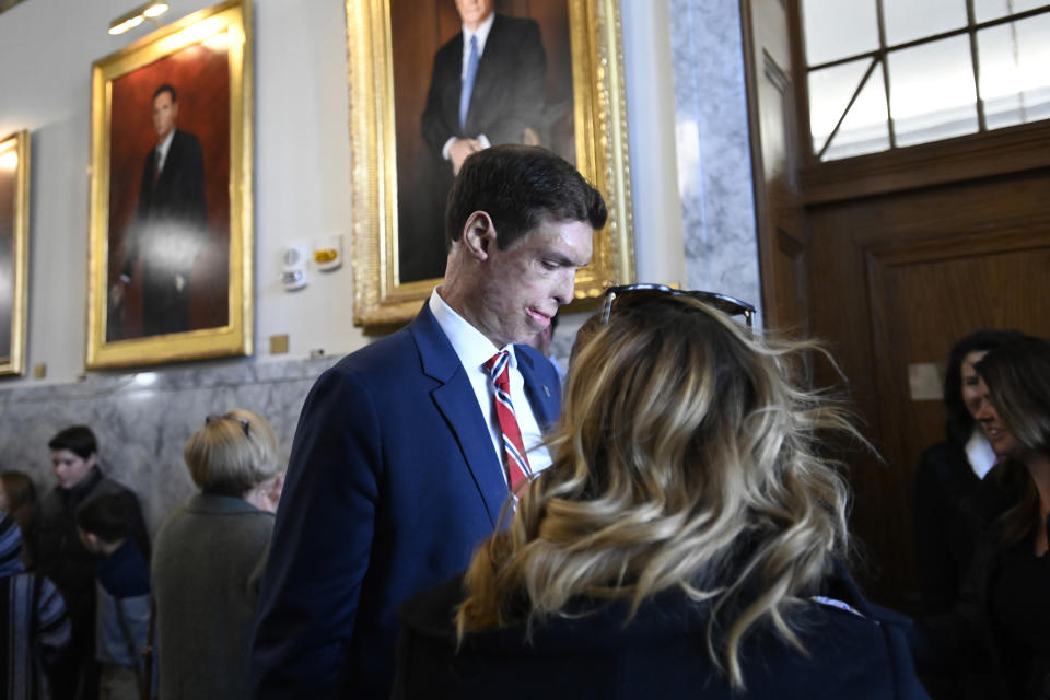 Republican U.S. Senatorial candidate Sam Brown talks with supporters as he arrives to files his paperwork to run for the Senate, Thursday, March 14, 2024, at the State Capitol in Carson City, Nev. Brown is seeking to replace incumbent U.S. Sen. Jacky Rosen. (AP Photo/Andy Barron)