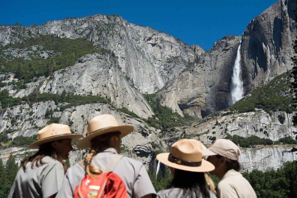 Park rangers in front of Yosemite falls.