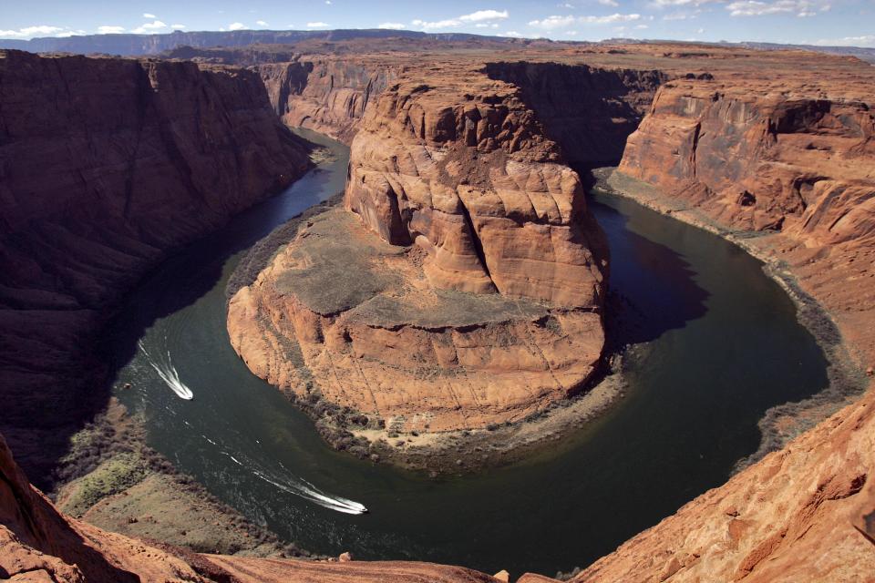 FILE - In this Wednesday, March 5, 2008 file photo, water levels at the Colorado River's Horseshoe Bend begin to rise along the beaches just hours after the Glen Canyon Dam jet tubes began releasing water, in Page, Ariz. Drought, climate change and an increasing population in the West are pushing the Colorado River basin toward deep trouble in the coming decades, scientists say. (AP Photo/Matt York)