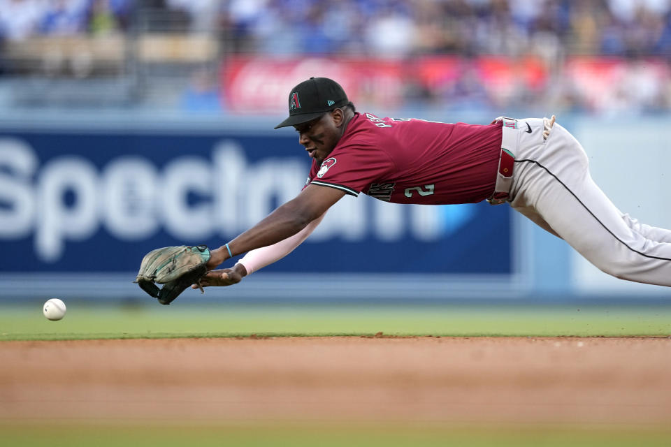 Arizona Diamondbacks shortstop Geraldo Perdomo dives for a ball hit for a single by Los Angeles Dodgers' Andy Pages during the first inning of a baseball game Wednesday, July 3, 2024, in Los Angeles. (AP Photo/Mark J. Terrill)