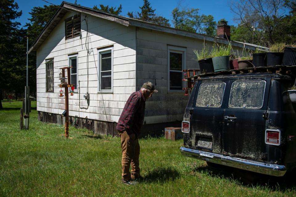 Bill Wasiowich, 83, checks on an old van repurposed as an elevated vegetable garden beside his home in the Pinelands of Woodmansie, New Jersey. Wasiowich, perhaps the last of the hunter-gatherers living off the Pinelands, lives on his own in a house he rents from a local gun club for $1000 a year.