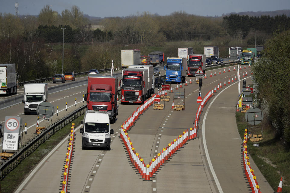 On the first day of Operation 'Brock', (Brexit Operations Across Kent) traffic passes through a contraflow system being tested on one side of the M20 motorway near Ashford, Kent, in south east England, Monday, March 25, 2019. The contraflow is designed to manage queues of trucks heading to Europe, via ferries or the Eurotunnel to France, in the event of a no-deal Brexit, to prevent gridlock for other road users. (AP Photo/Matt Dunham)