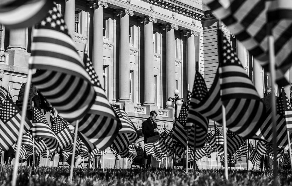 Governor Andy Beshear delivers remarks during a ceremony remembering those lost to COVID-19 on Friday, January 22, 2021 in Frankfort, Kentucky.  3301 flags, each representing one person lost to the virus were planted behind the Kentucky State Capitol