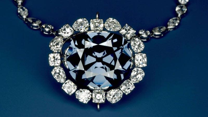 The Hope Diamond in a pendant of white diamonds. - Photo: <a class="link " href="https://www.si.edu/spotlight/hope-diamond" rel="nofollow noopener" target="_blank" data-ylk="slk:Chip Clark / Smithsonian Institution;elm:context_link;itc:0;sec:content-canvas">Chip Clark / Smithsonian Institution</a>