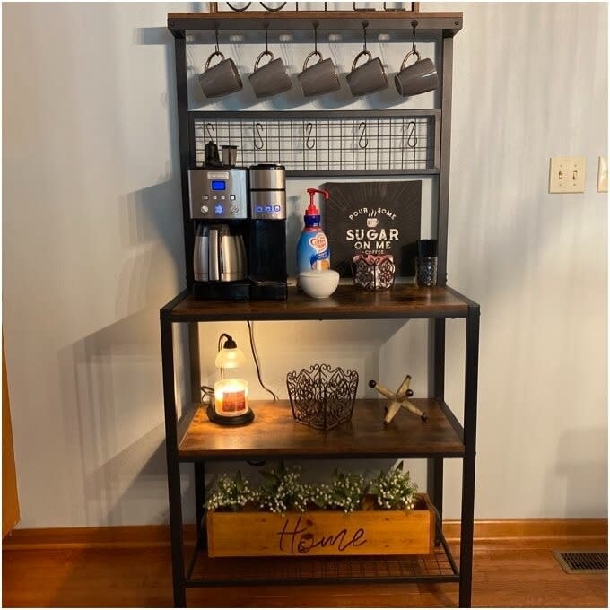 A coffee station with a machine, mugs, and decorative items with the phrase "Sugar on me" displayed