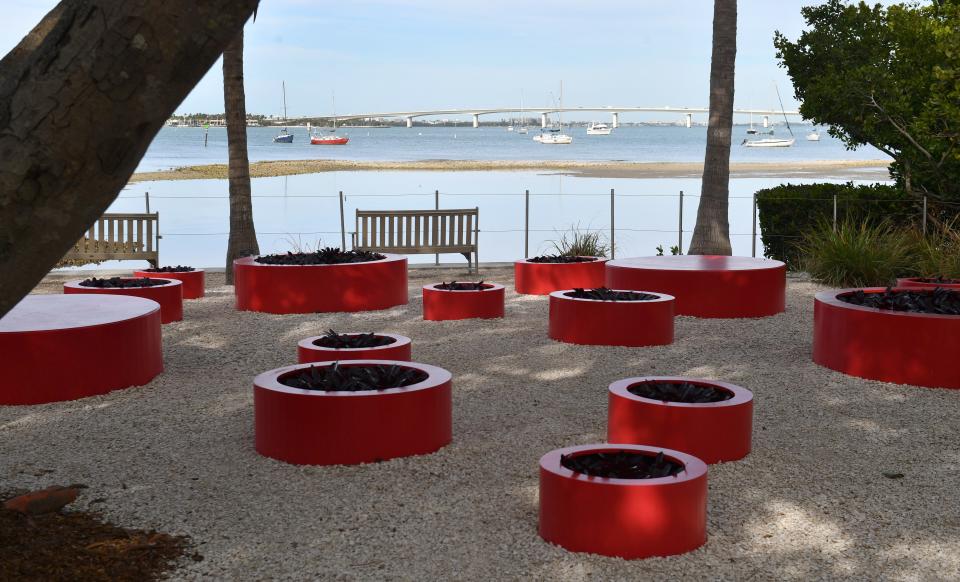 Red, circular planters in the "Pops of Red" display, pay homage to Yayoi Kusama's Infinity Dots series.