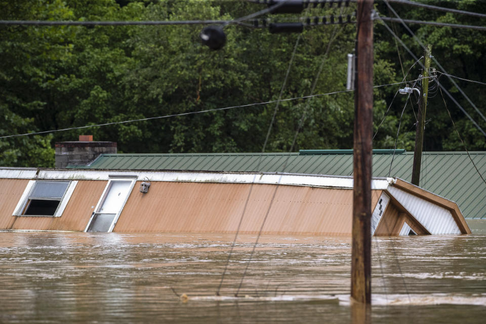 Homes are flooded by Lost Creek, Ky., on Thursday, July 28, 2022. Heavy rains have caused flash flooding and mudslides as storms pound parts of central Appalachia. Kentucky Gov. Andy Beshear says it's some of the worst flooding in state history. (Ryan C. Hermens/Lexington Herald-Leader via AP)