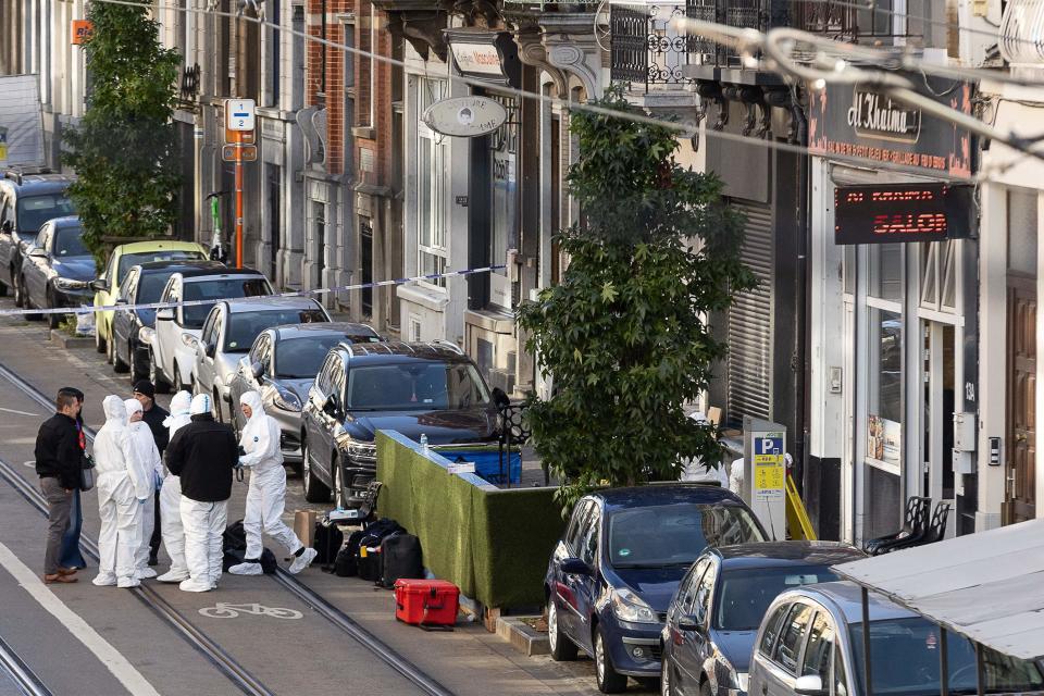 Belgian police officers from the forensic service gather in the street outside the cafe Al Khaima, Brussels (BELGA/AFP via Getty Images)