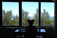 Guinean wrestler Fatoumata Yarie Camara poses as she sits in the restaurant of the Ostia's Olympic training center, near Rome, Monday, July 5, 2021. A West African wrestler's dream of competing in the Olympics has come down to a plane ticket. Fatoumata Yarie Camara is the only Guinean athlete to qualify for these Games. She was ready for Tokyo, but confusion over travel reigned for weeks. The 25-year-old and her family can't afford it. Guinean officials promised a ticket, but at the last minute announced a withdrawal from the Olympics over COVID-19 concerns. Under international pressure, Guinea reversed its decision. (AP Photo/Alessandra Tarantino)