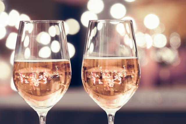 Wine glasses against bokeh background. New Year's celebration.