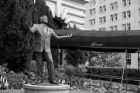 A statue of singer Tony Bennett stands outside the closed Fairmont Hotel in San Francisco on April 17, 2020. Normally, the months leading into summer bring bustling crowds to the city's famous landmarks, but this year, because of the coronavirus threat they sit empty and quiet. Some parts are like eerie ghost towns or stark scenes from a science fiction movie. (AP Photo/Eric Risberg)