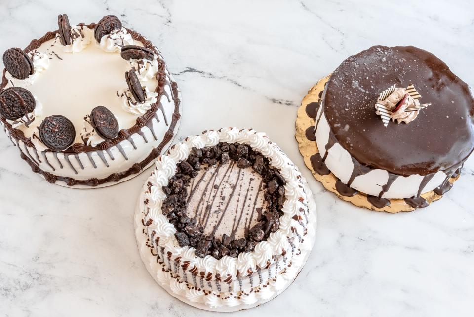 three ice cream cakes on a marble countertop