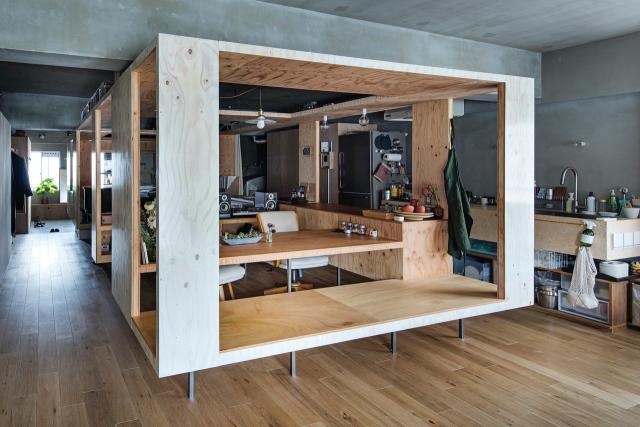 Stained plywood box houses kitchen and bedroom in renovated Seattle condo