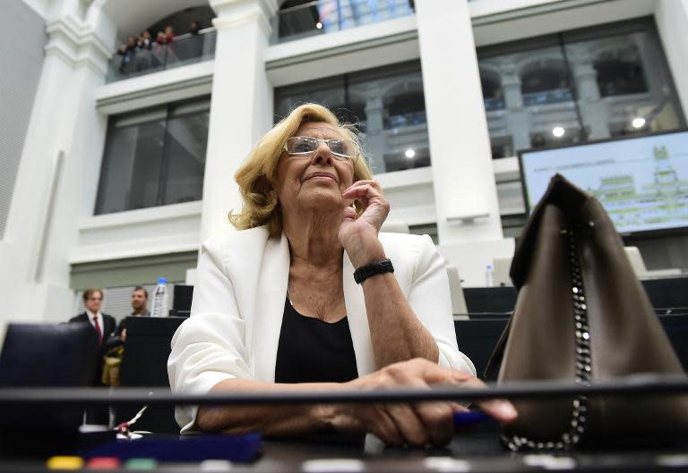 Manuela Carmena smiles at the Cibeles Palace in Madrid, prior to being sworn in during the investiture session on June 13, 2015