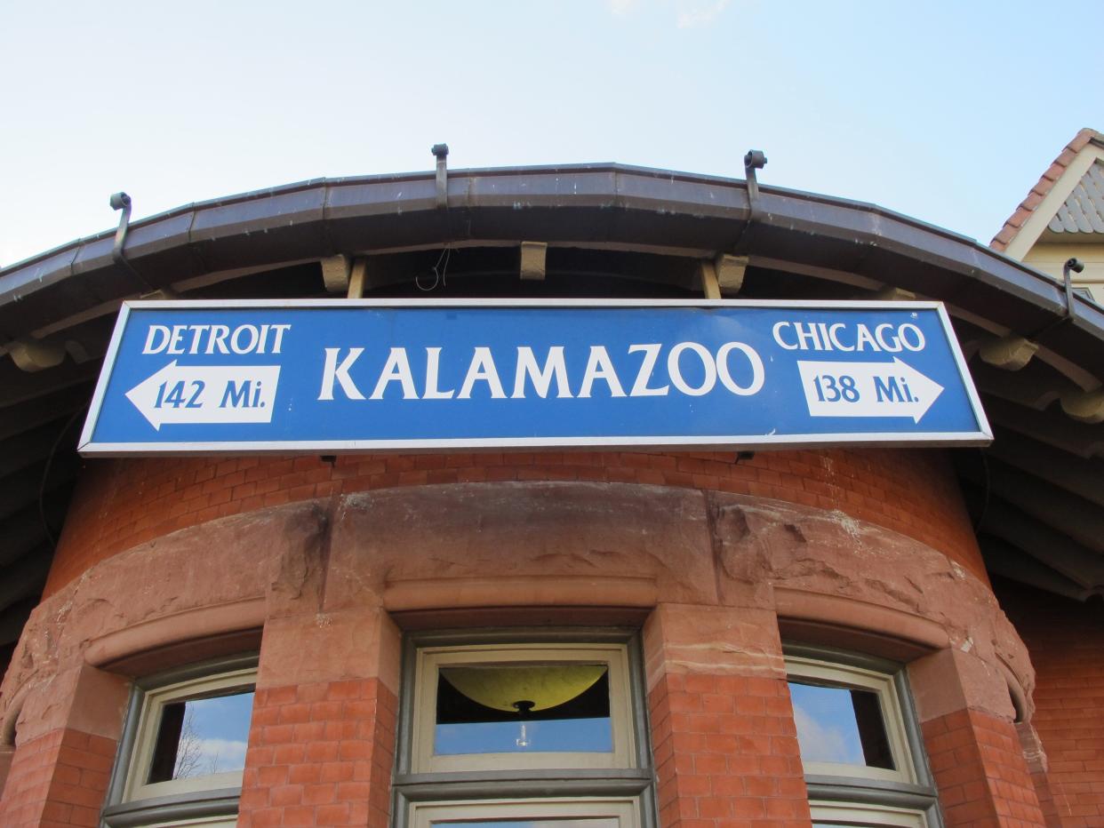 A sign at the train station for Amtrak service between Kalamazoo and Dearborn, a suburb of Detroit. Kalamazoo, where public high school graduates can get free tuition at any public college in Michigan, is about 135 miles directly west of Detroit.