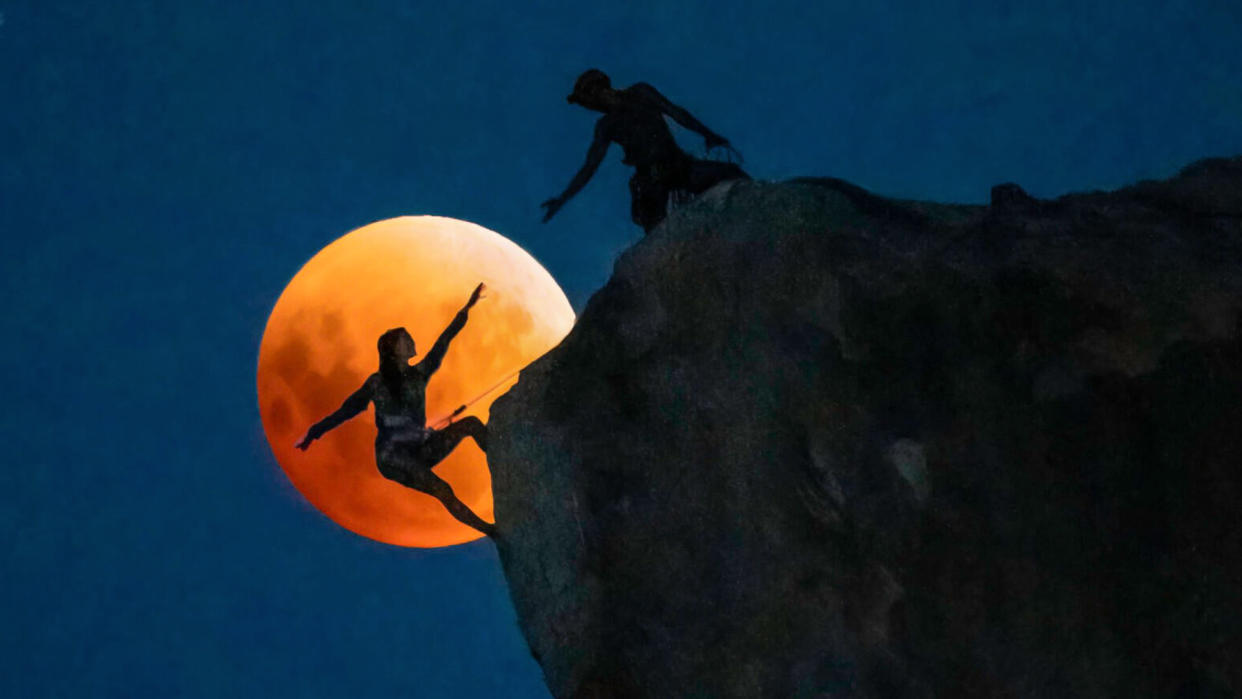  2022 first-place winner in the Connecting to the Dark category was ‘Rock climbers under a rising blood moon’ by by Chris Olivas 