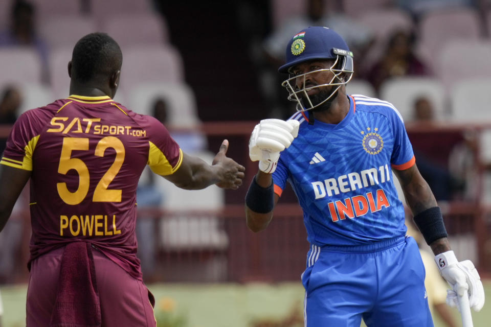 West Indies' captain Rovman Powell shakes hands with India's captain Hardik Pandya at the end of their third T20 cricket match at Providence Stadium in Georgetown, Trinidad and Tobago, Tuesday, Aug. 8, 2023. India won by 7 wickets. (AP Photo/Ramon Espinosa)