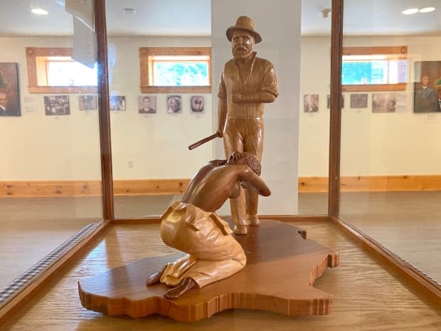 A carving by artist Bruce Jacquard depicts an enslaved woman named Jude being beaten by her owner. She died from her injuries in Nova Scotia in 1800. The carving is on display at the Yarmouth County Museum.   (Brian MacKay/CBC - image credit)