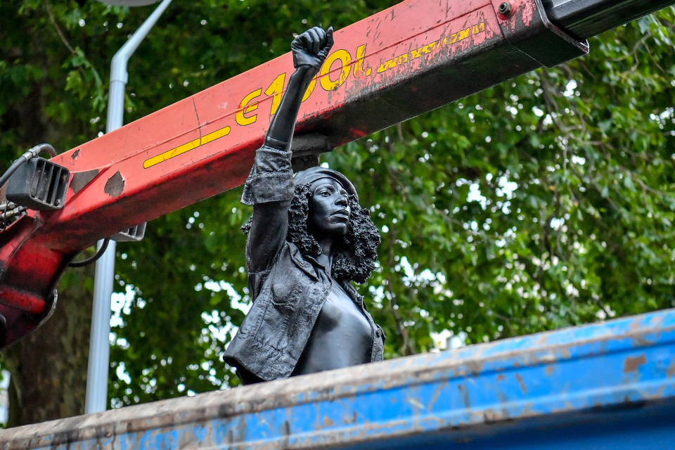 A Surge of Power (Jen Reid) 2020, by prominent British sculptor Marc Quinn, which has been installed in Bristol on the site of the fallen statue of the slave trader Edward Colston, is removed from the plinth and loaded into a recycling and skip hire lorry.