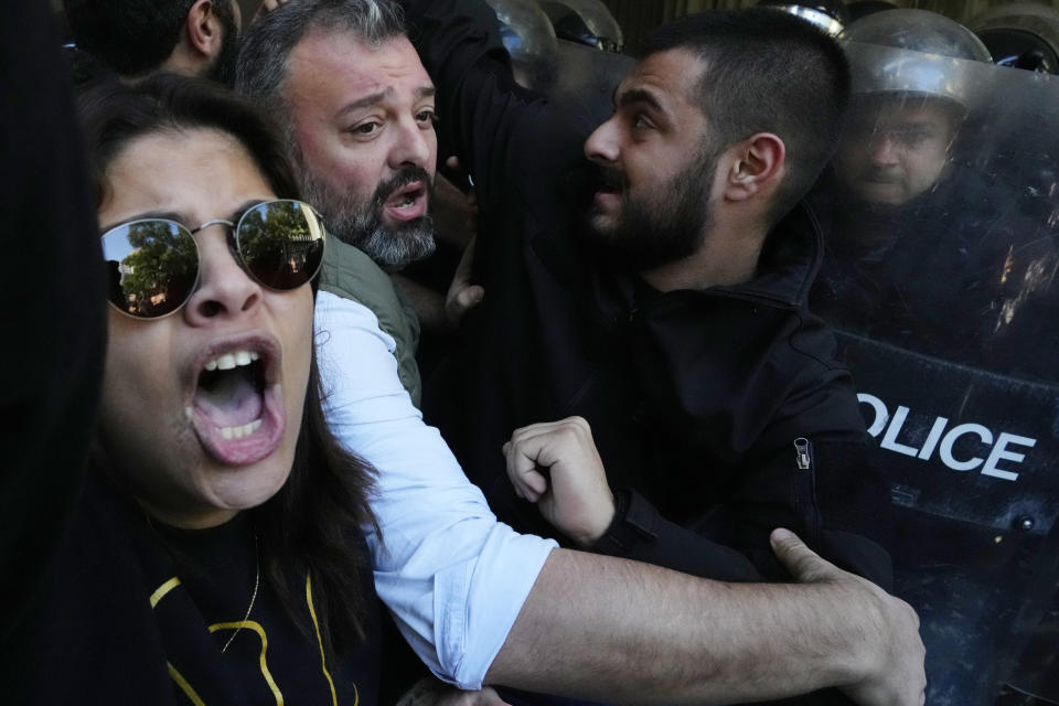 Anti-government protesters scuffle with riot police outside the ministry of Justice, in Beirut, Lebanon, Thursday, Jan. 26, 2023. Scores of protesters Thursday scuffled with riot police as they tried to break into the Beirut Justice Palace, rejecting an order from Lebanon's judiciary that further crippled the probe into a massive port explosion over two years ago. (AP Photo/Hassan Ammar)