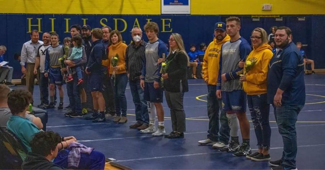 Logan Horn, Quade Mesarosh , Brodie Spratt, Emmett Woodcox, and Carson Loader join their family during the Senior Night honors.