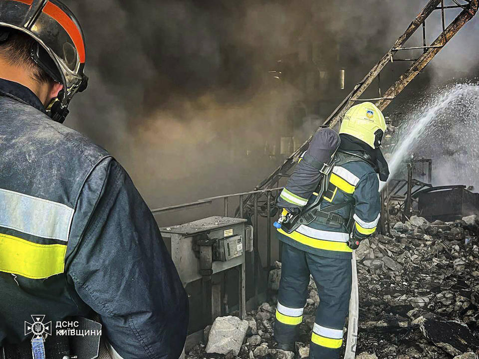 In this photo provided by the Ukrainian Emergency Service, emergency workers extinguish a fire after a Russian attack on the Trypilska thermal power plant in Ukrainka, Kyiv region, Ukraine, Thursday, April 11, 2024. (Ukrainian Emergency Service via AP)