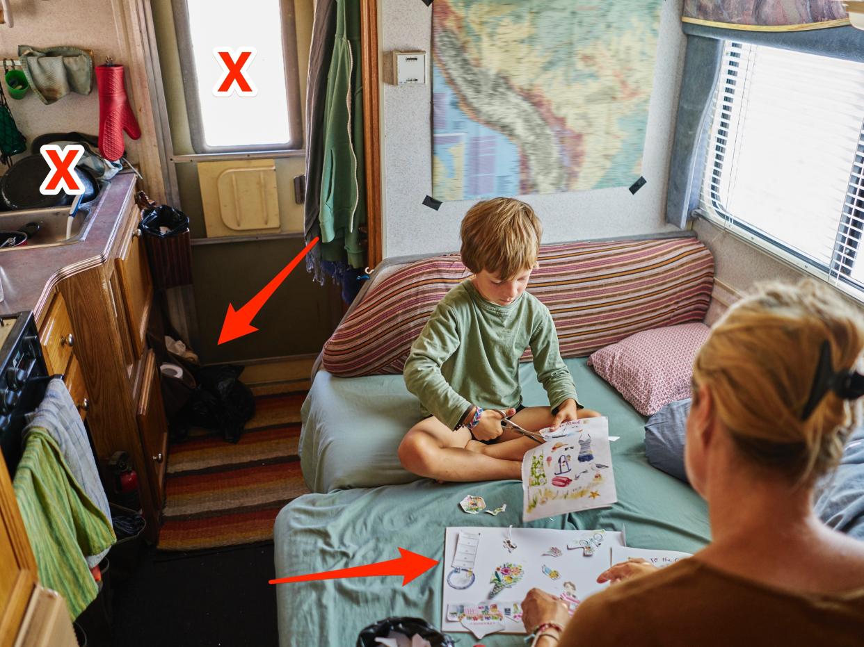 Mother and son cutting out pictures in camper van X's and arrows over 4 spots that are cluttered and stressful