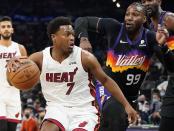 Miami Heat's Kyle Lowry (7) keeps the ball away from Phoenix Suns' Jae Crowder (99) during the first half of an NBA basketball game Saturday, Jan. 8, 2022, in Phoenix. (AP Photo/Darryl Webb)